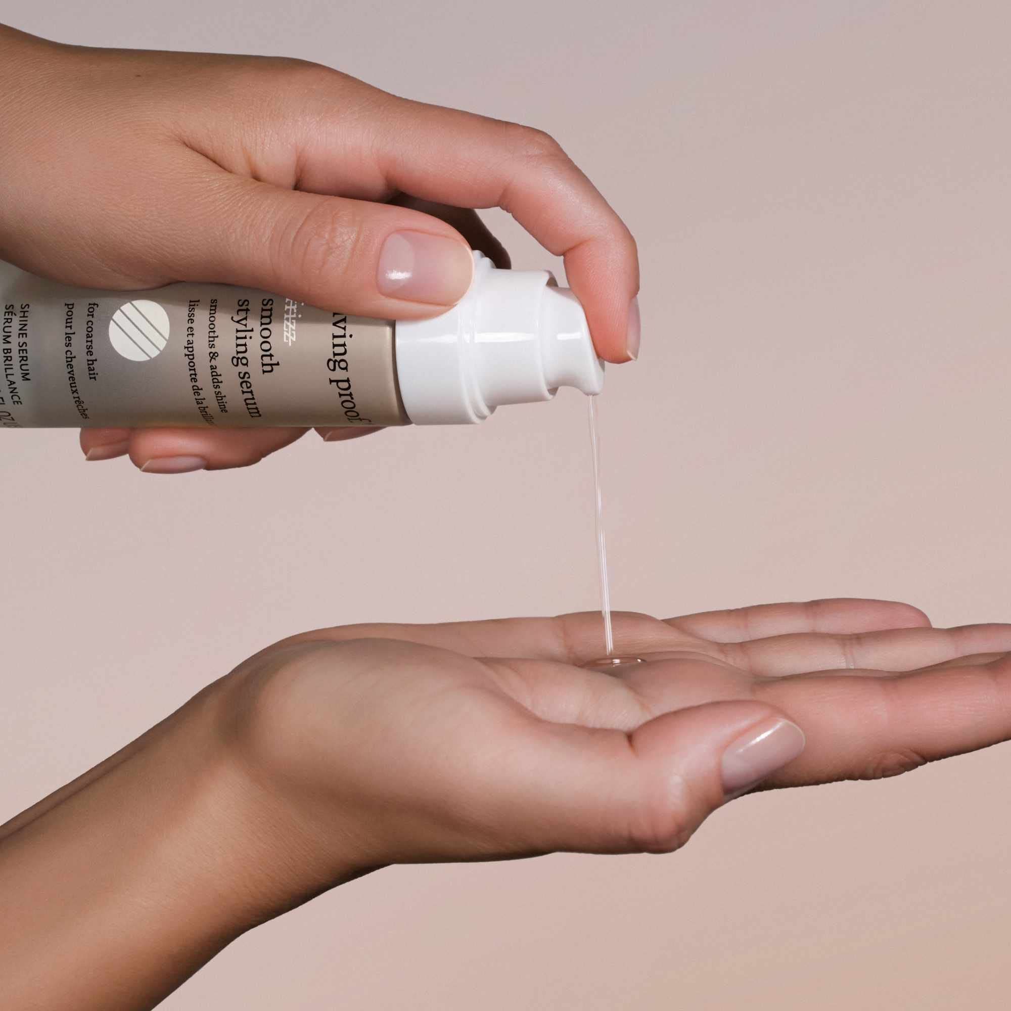 Living Proof No Frizz Smooth Serum hand application demonstrates lightweight finish