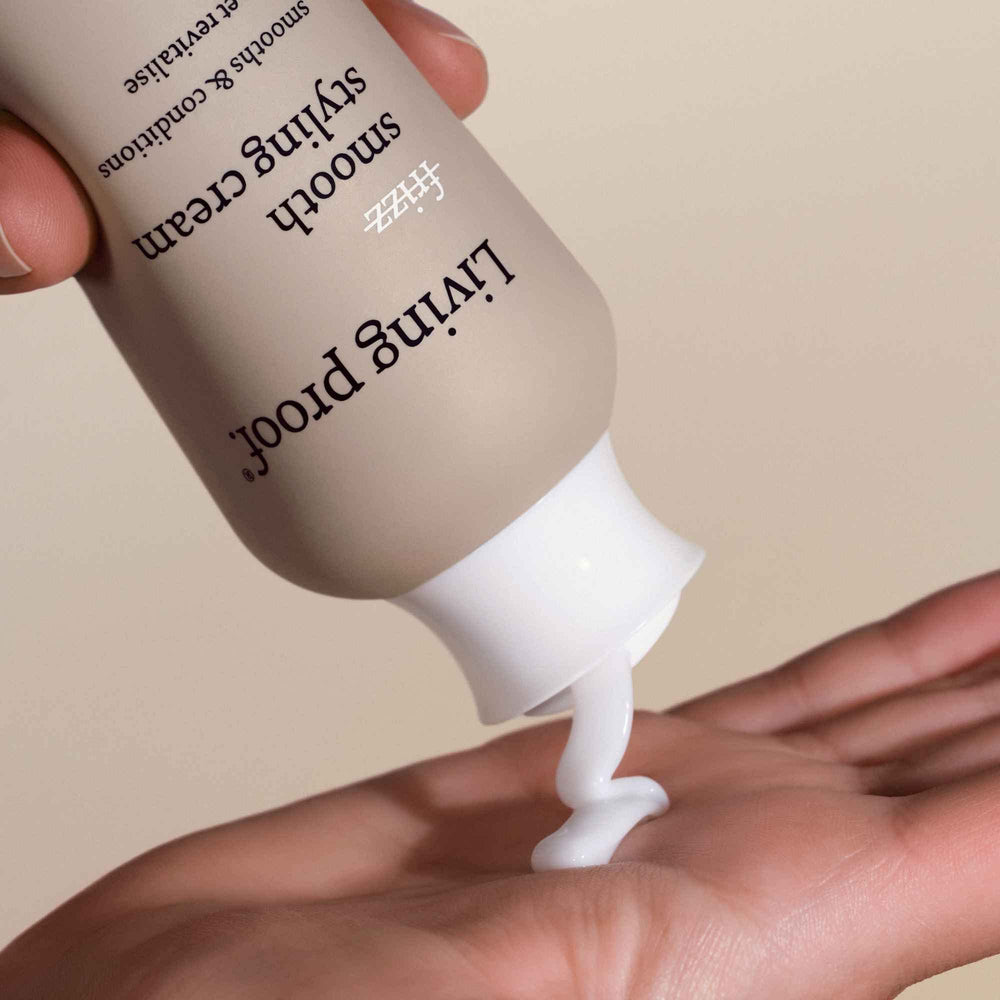 Living Proof No Frizz Smooth Styling Cream on a blow dryer to show heat protection