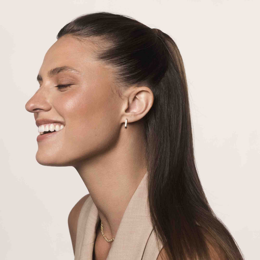 Living Proof No Frizz Smooth Styling Cream hands applying the cream for frizz control