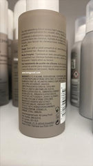 Living Proof No Frizz Vanishing Oil drop on palm illustrates lightweight hydration boost.