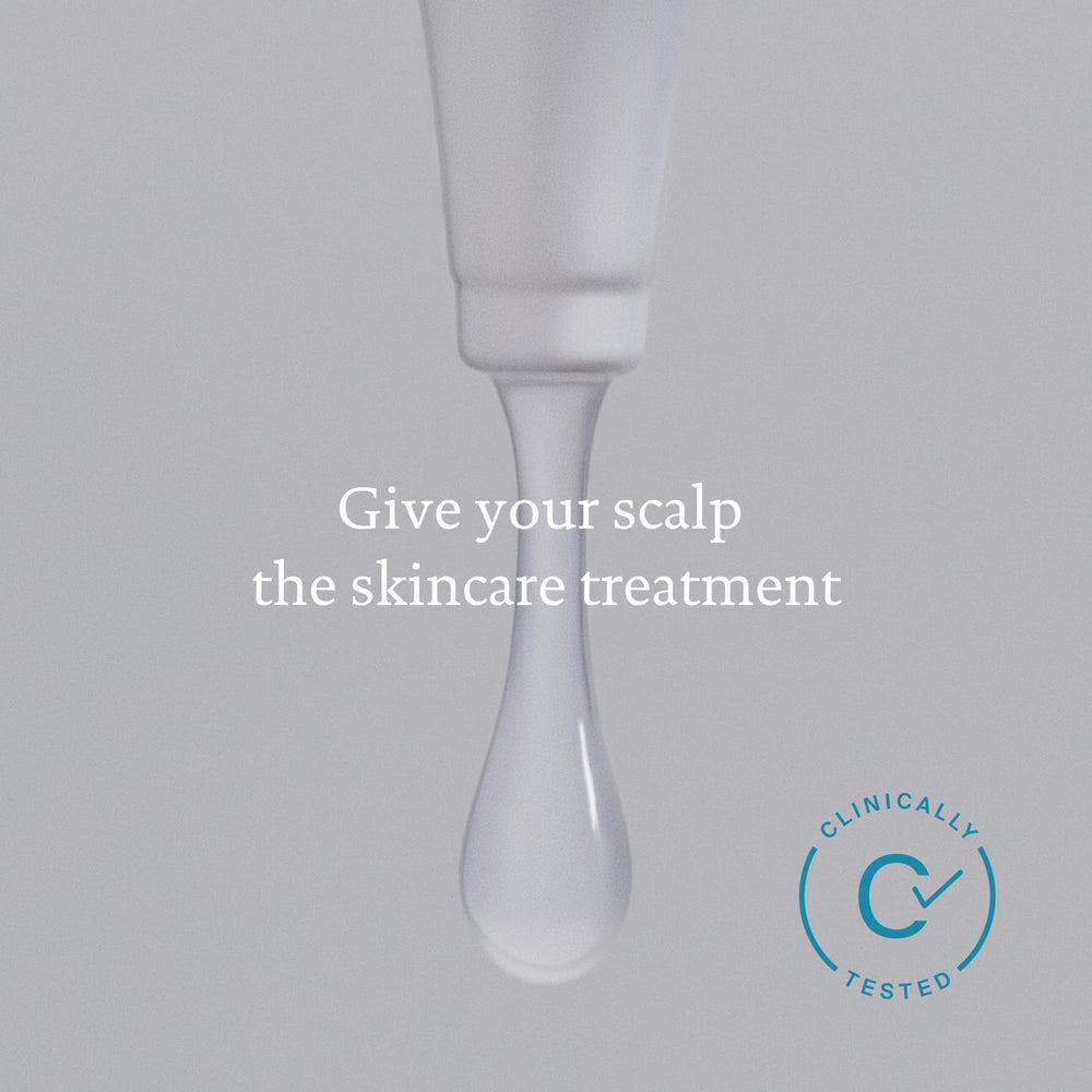Living Proof routine setup with towel and brush implies at-home care.