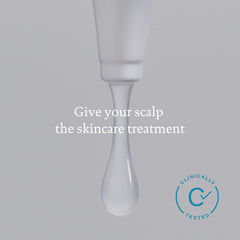 Living Proof routine setup with towel and brush implies at-home care.