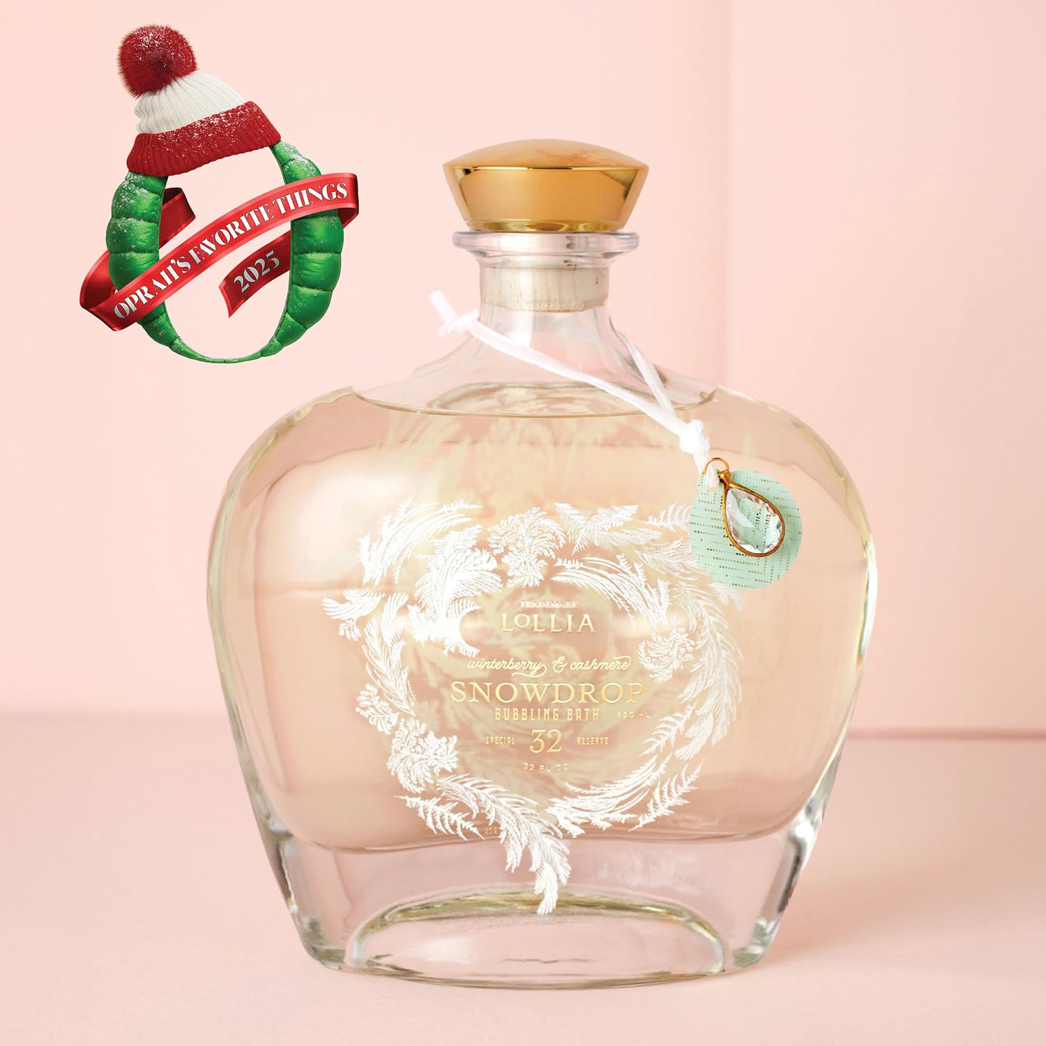 Lollia Snowdrop Bubble Bath bottle close-up highlights Winterberry and Cashmere notes.