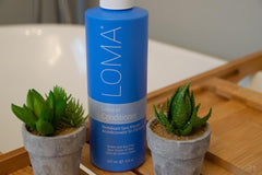 Loma leave-in conditioner applying mist to damp hair for smooth detangle.