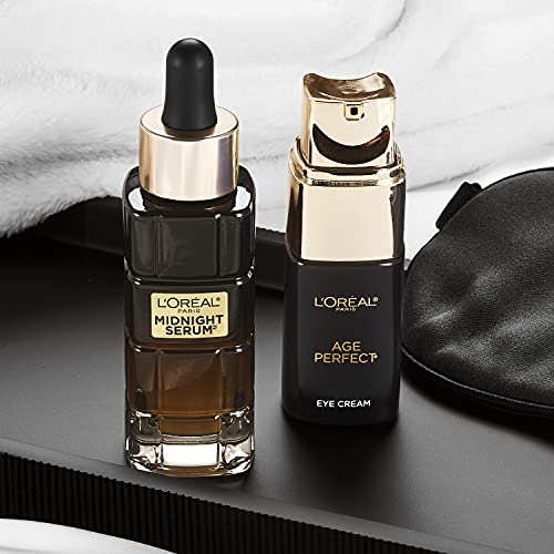 L'Oreal Paris Age Perfect eye cream bottle reflected on a surface.