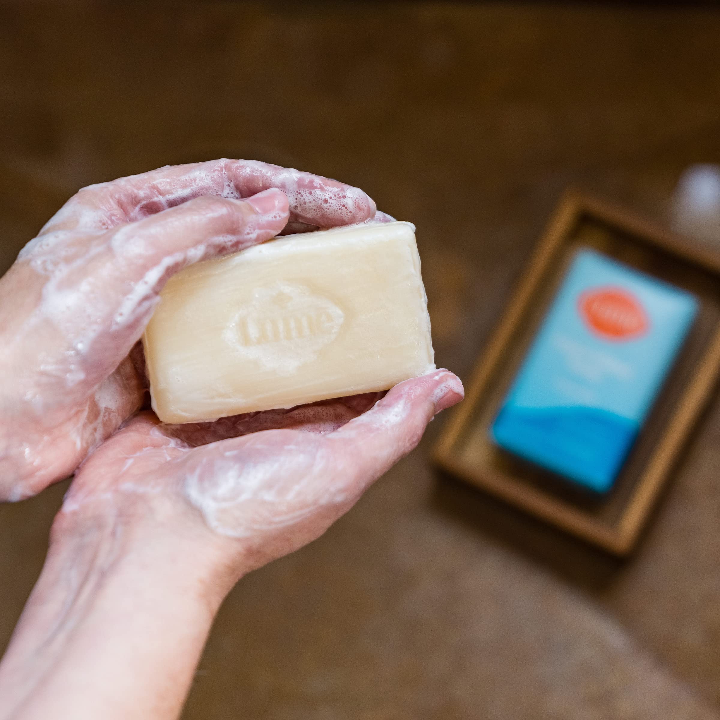 Lume triple-milled bar soap luxurious-lather close-up showing dense foam.
