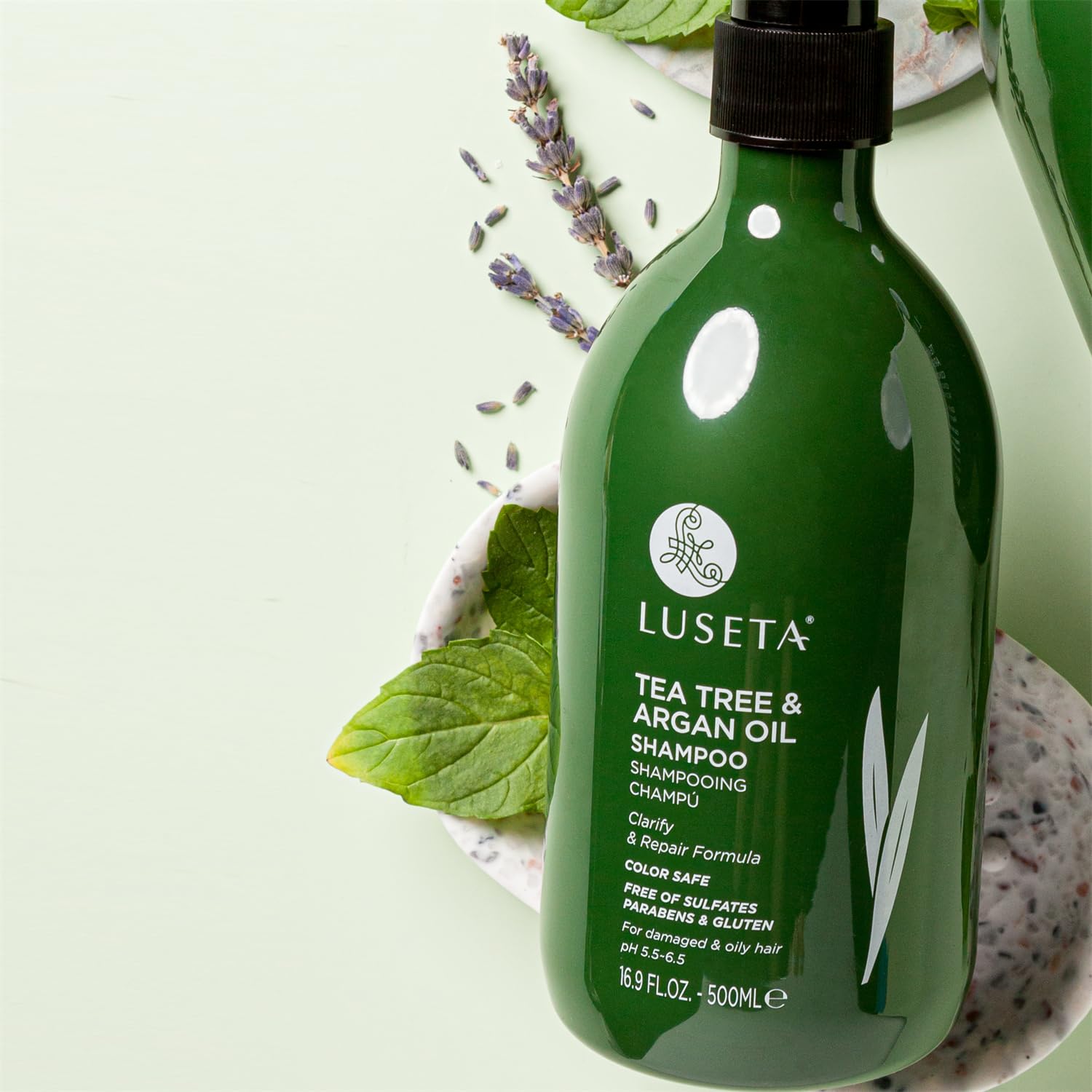 Luseta Tea Tree Shampoo bottle with hair in background evokes healthy, vibrant-looking hair.