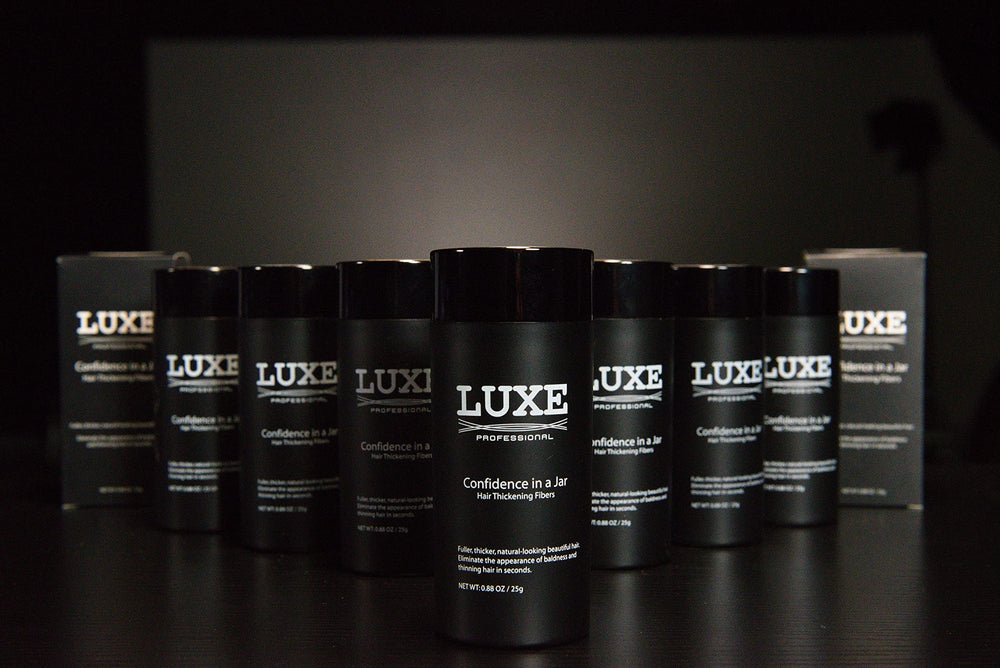 LUXE Hair Building Fibers color-black on dark roots for seamless blend.