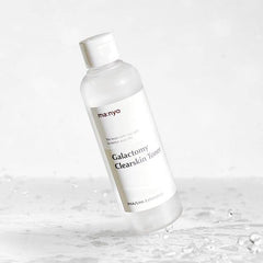 ma:nyo Galactomy Clear Skin Toner on cotton pad for gentle exfoliation