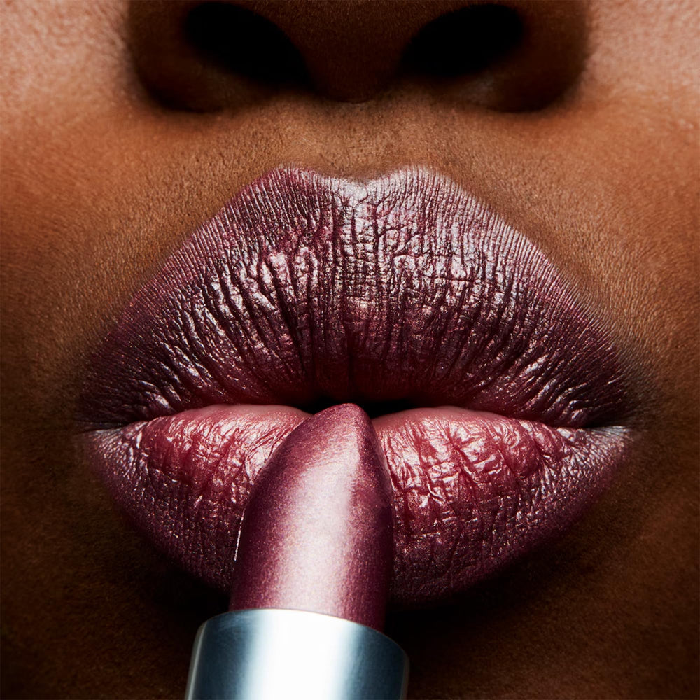 MAC Frost Lipstick Plum Dandy swatch on skin showing buildable color and glow.