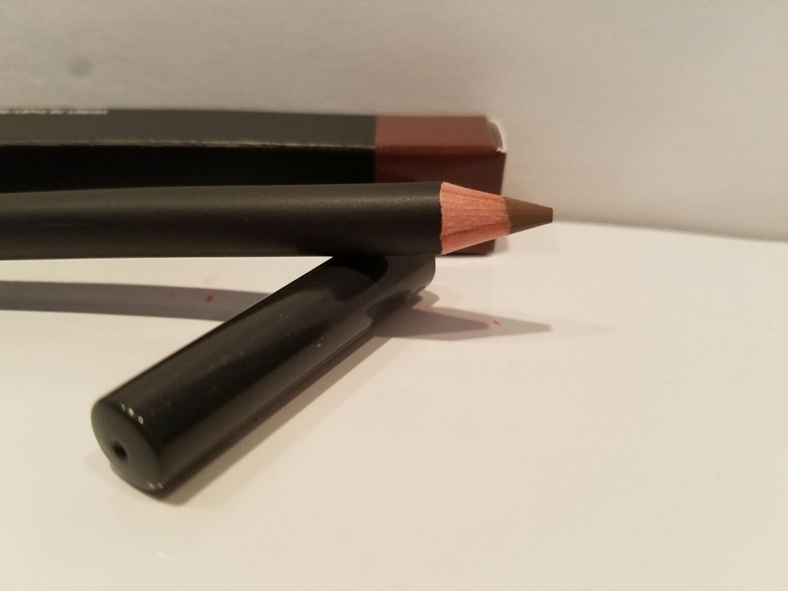 MAC Lip Pencil Cork in a makeup bag highlights essential tool for defined lips.