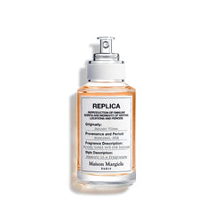 Maison Margiela Replica Autumn Vibes bottle on a warm surface, signaling timeless elegance for daily fragrance routines.
