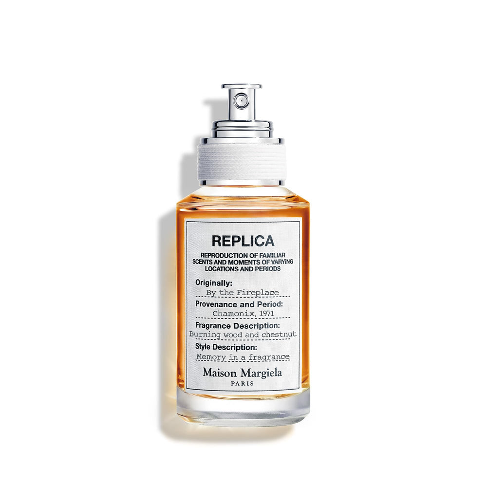 Maison Margiela Replica By the Fireplace bottle glowing on a mantel, warm evenings await.