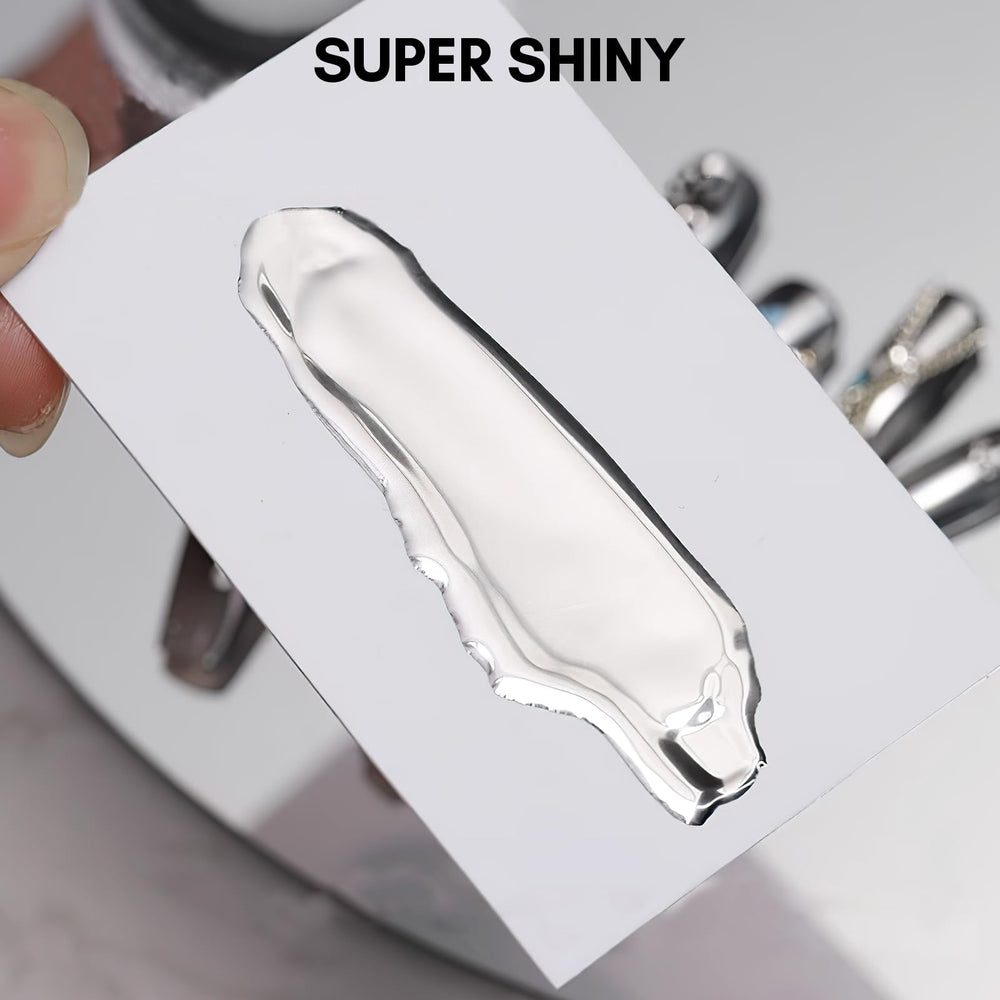 Makartt glossy chrome nails under LED light emphasize reflective surface.