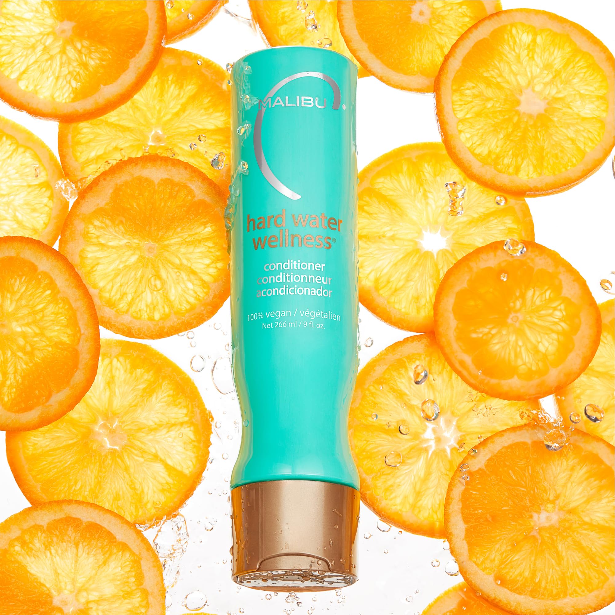 Malibu C Hard Water Wellness Conditioner label closeup highlights vegan plant-based nourishment.