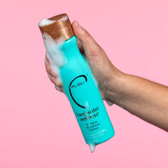 Malibu C Hard Water Wellness Shampoo label closeup highlights mineral protection and color-safe cleansing
