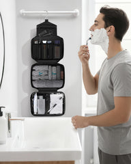 Maliton toiletry bag hanging in shower demonstrates easy access to essentials during travel.