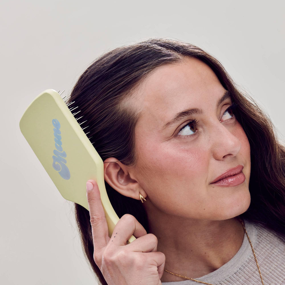 Mane Ready or Knot brush on towel-dried hair demonstrating easy detangling and oil distribution