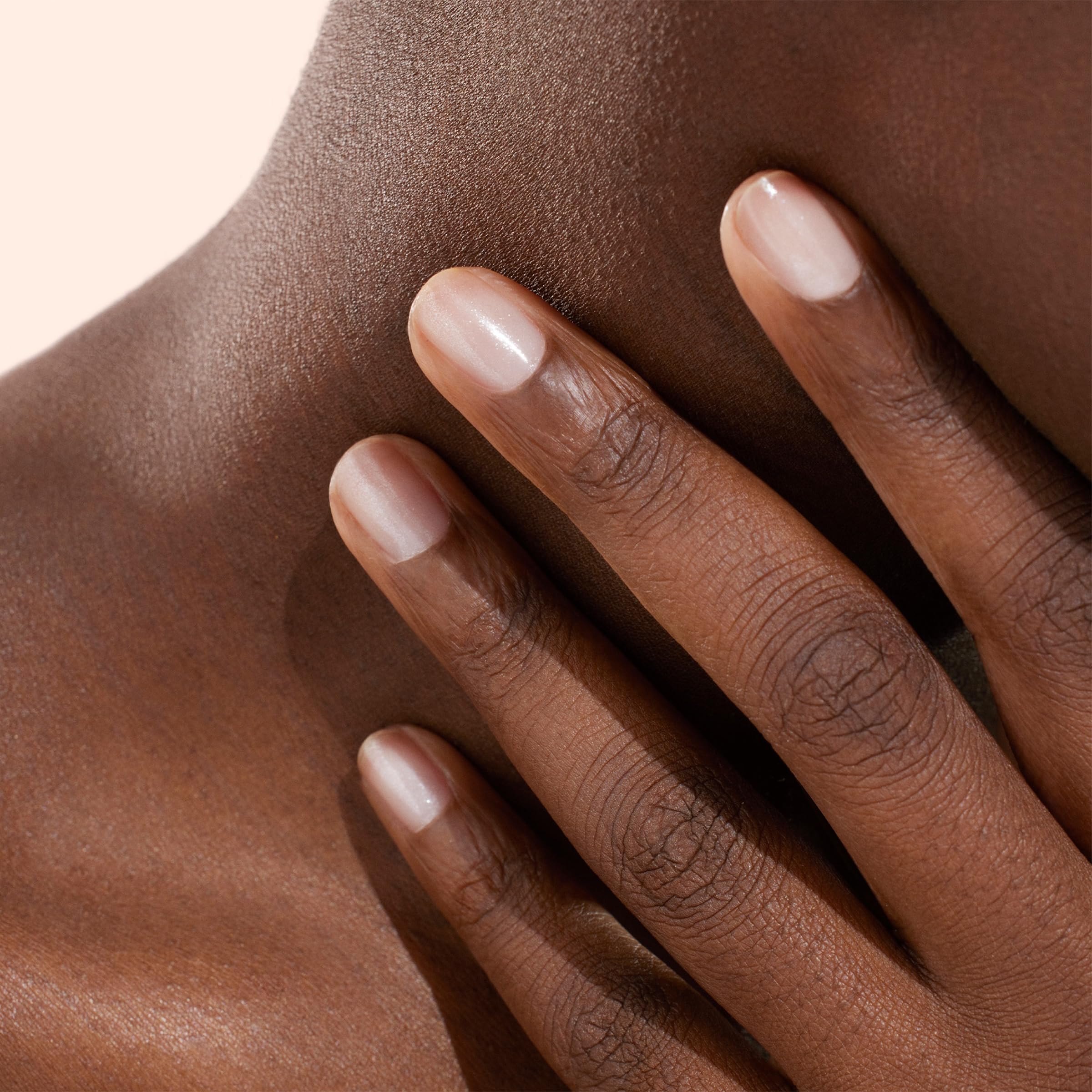 Manucurist Active Shine application showing beige concealing shimmer on nails.