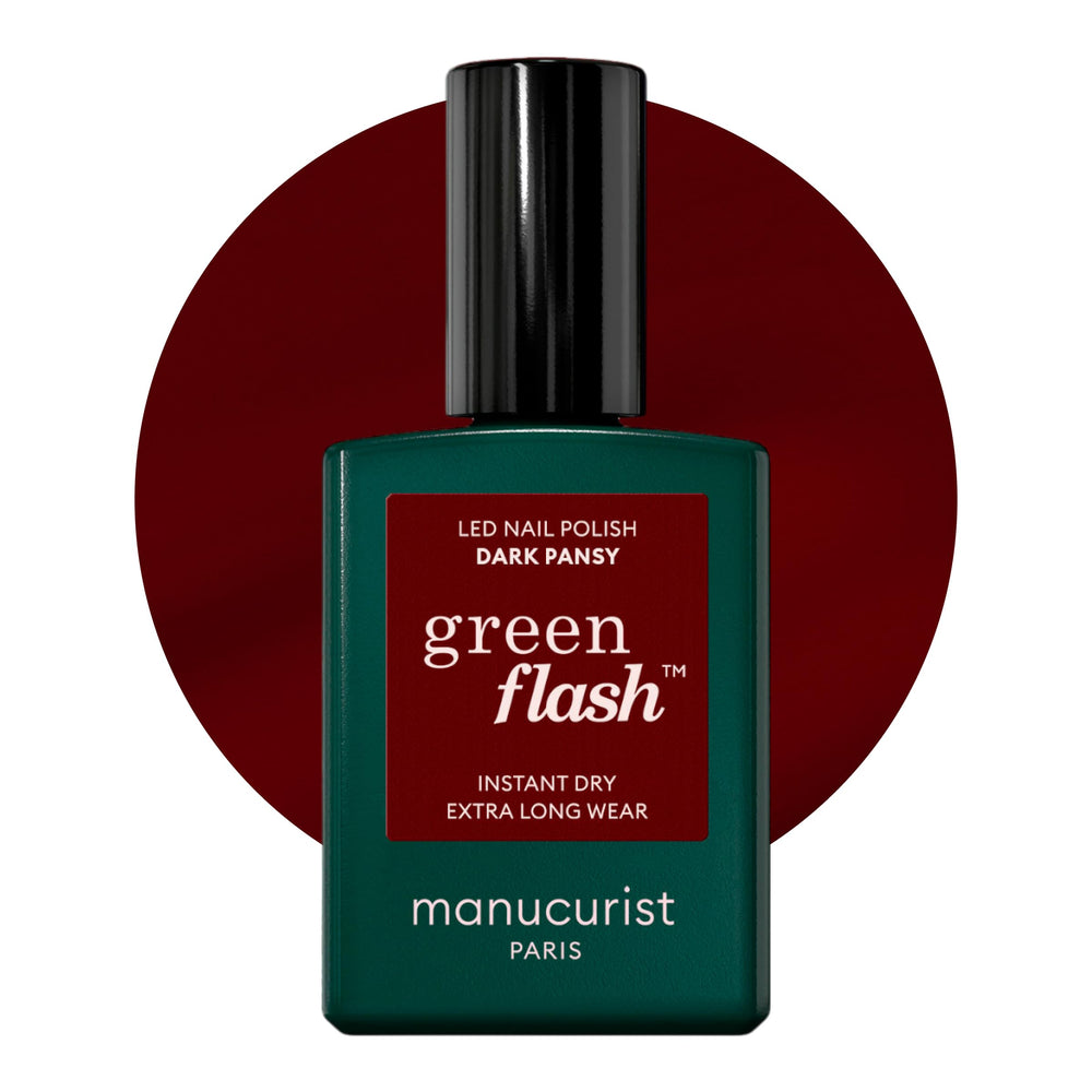 Manucurist Green Flash Dark Pansy bottle closeup, vegan plant-based gel polish for burgundy nails.