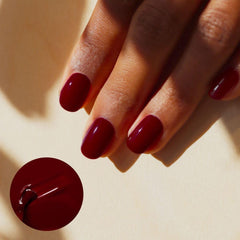 Manucurist Green Flash Dark Pansy nails on hand showing opaque burgundy coverage.