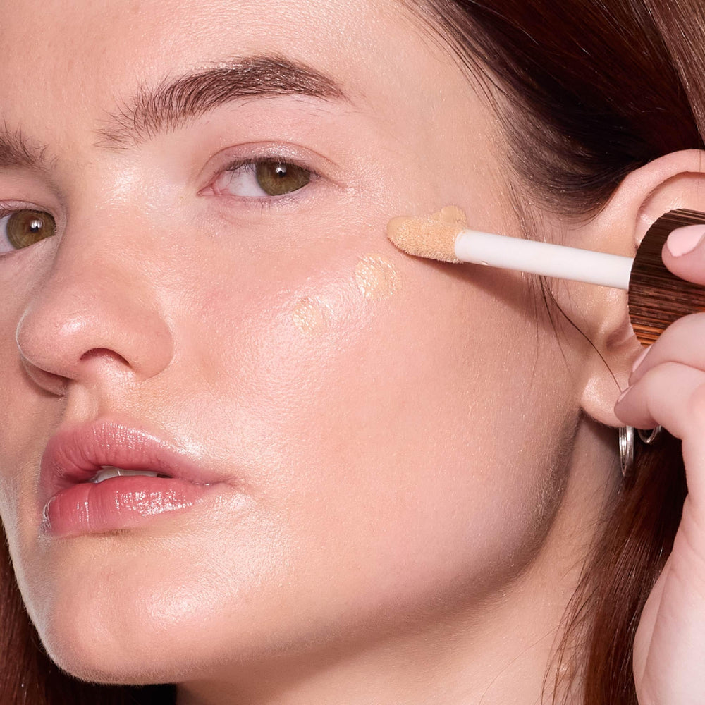 MCoBeauty Flawless Glow Filter on cheekbones as liquid highlighter adds dimension.