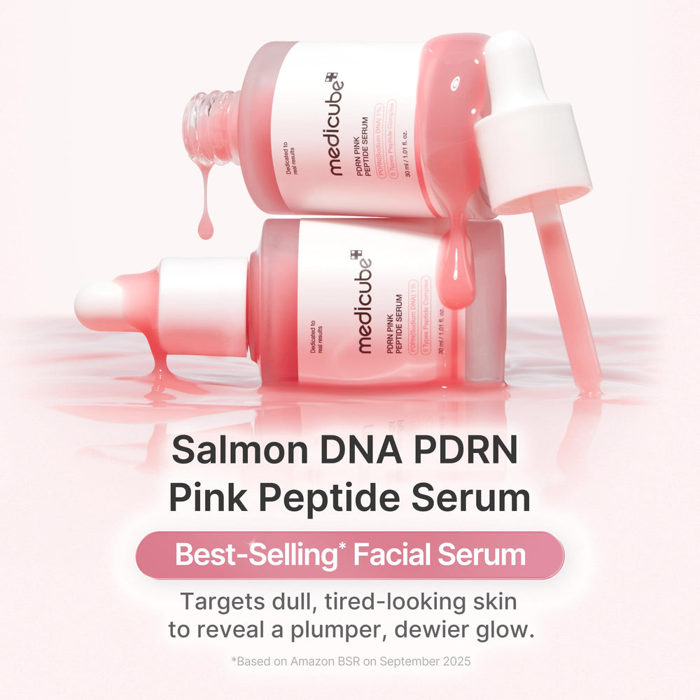 Medicube pink glow serum dropper releasing serum for instant hydration on skin.