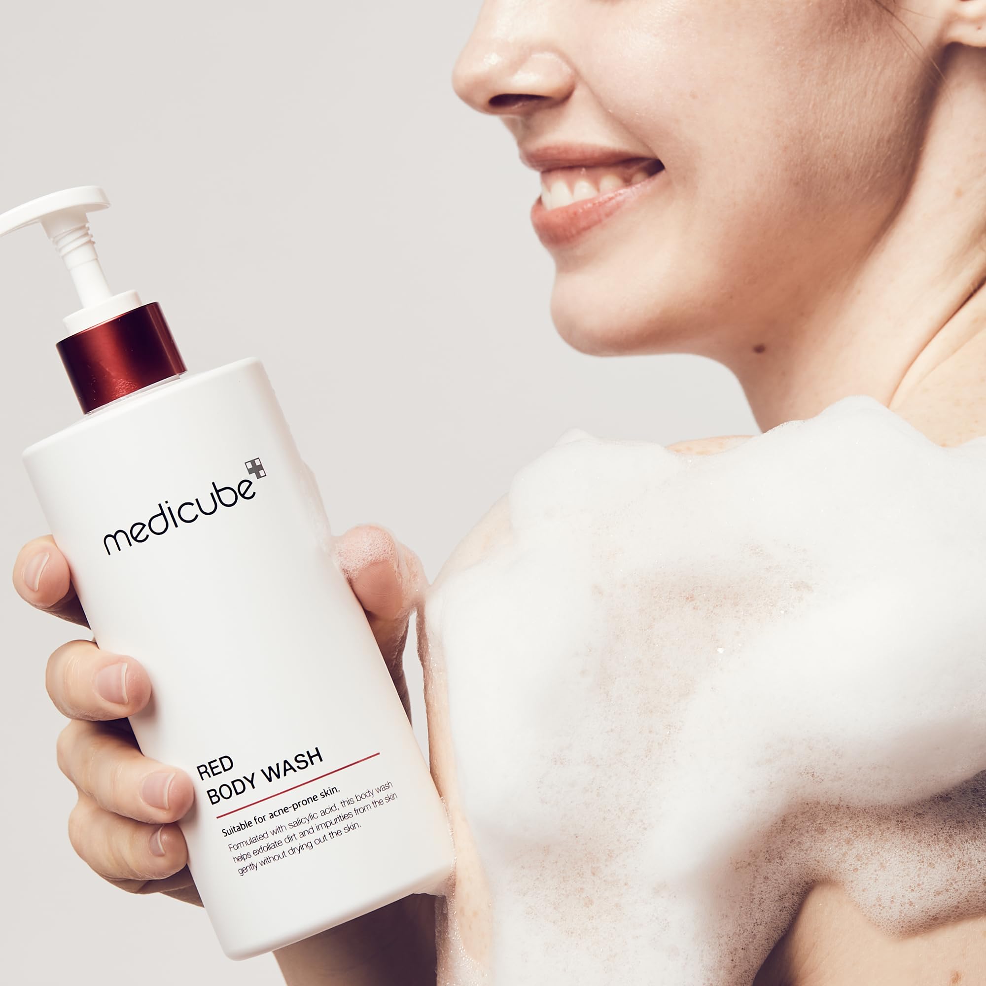 Lathering Medicube Red Body Wash on arm shows gentle exfoliation and hydration