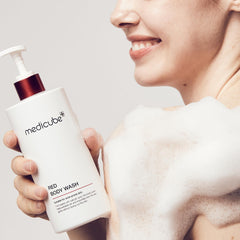 Lathering Medicube Red Body Wash on arm shows gentle exfoliation and hydration