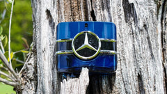 Mercedes-Benz Sign woody base notes image emphasizes patchouli and tonka bean warmth.