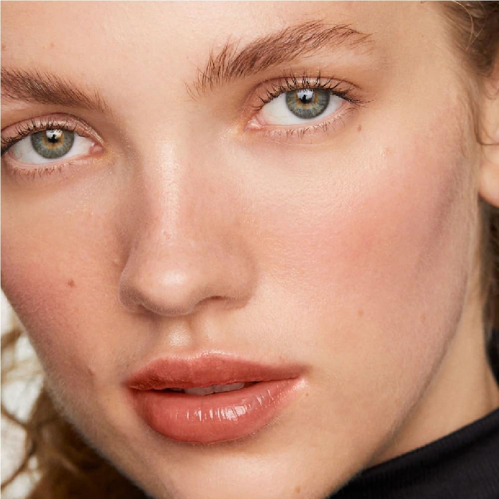 Merit Mascara wand closeup highlights precision brush for defined, fluttery lashes.