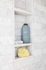 Forest-inspired Cedar + Cypress fragrance showcased on the bottle.
