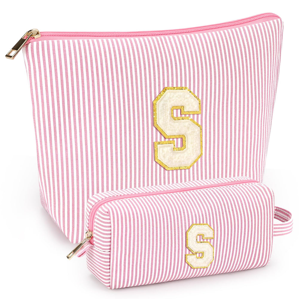 Mibasies two-piece initial makeup bag in light pink opens to reveal organized compartments for travel cosmetics.