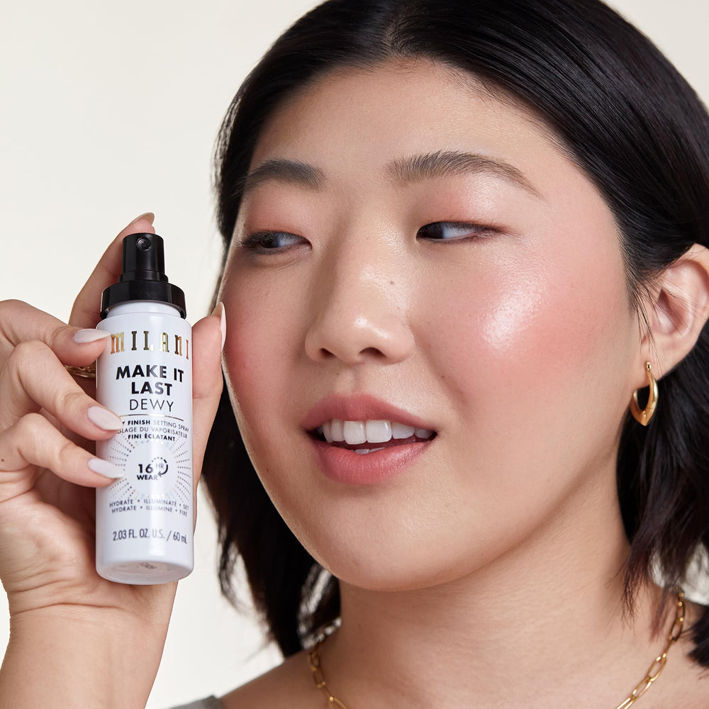 Milani Make It Dewy setting spray in makeup bag ready for on-the-go refresh.