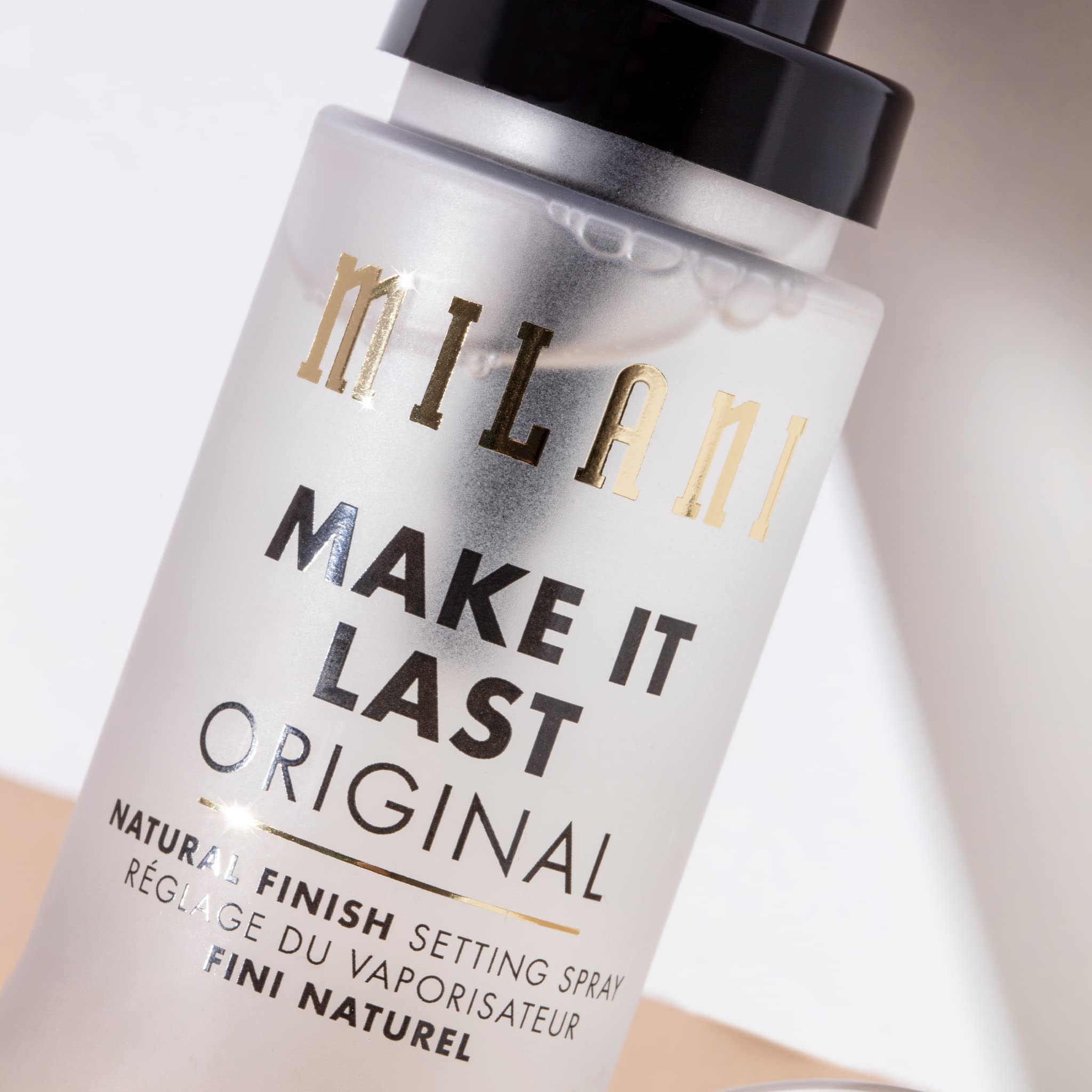 Milani under-over makeup spray demonstrates versatile use for setting or refreshing.