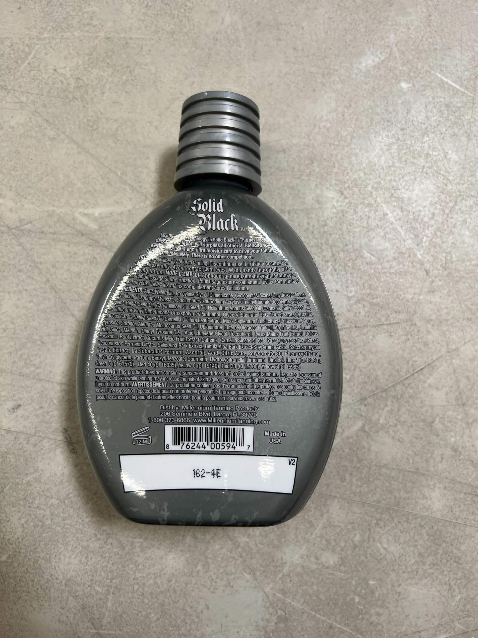 Millennium Tanning Solid Black 100X 400ml packaging highlights value.