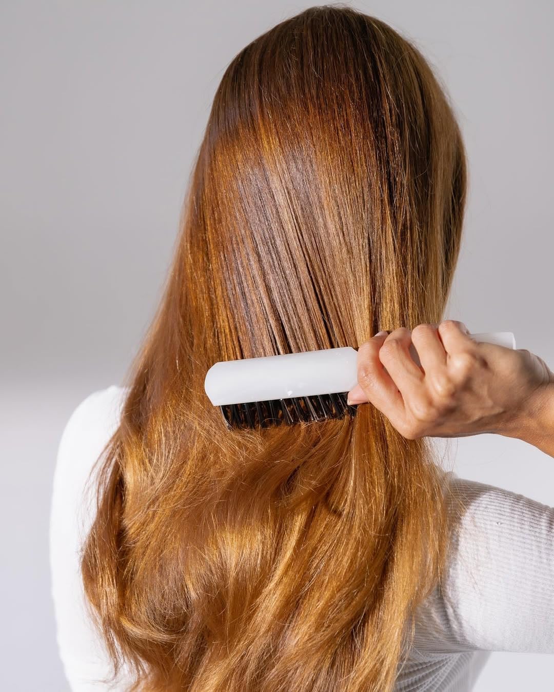 Mirta De Perales daily hairbrush used on ponytail for sleek, tension-free styling.