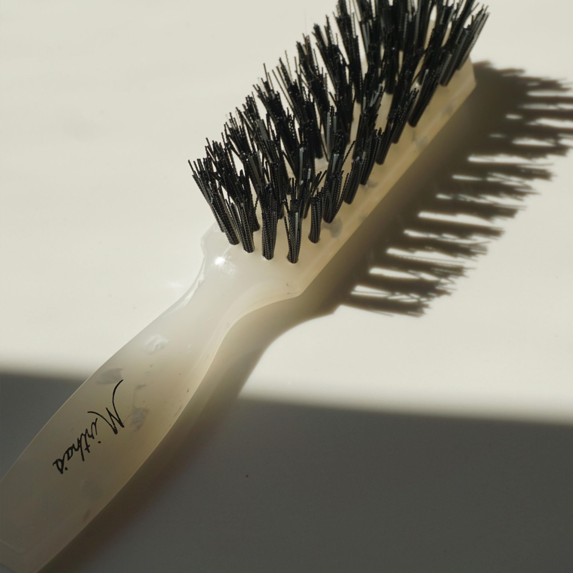 Mirta De Perales brush creates a smooth bun with frizz control.