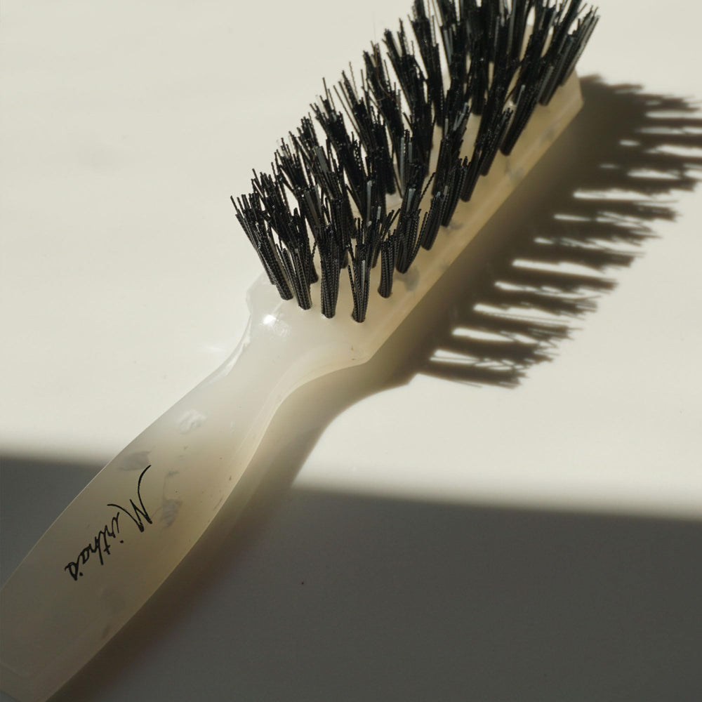 Mirta De Perales brush creates a smooth bun with frizz control.