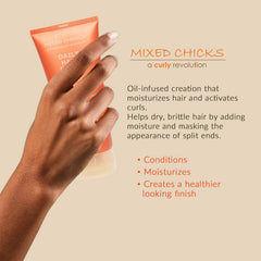Hands applying Mixed Chicks Daily Hair Dress for smooth, hydrated hair