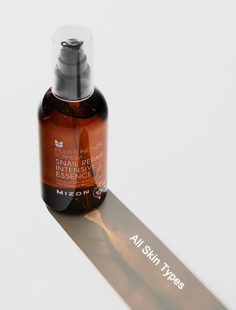 MIZON Snail Repair Intensive Essence hydration glow on skin surface.