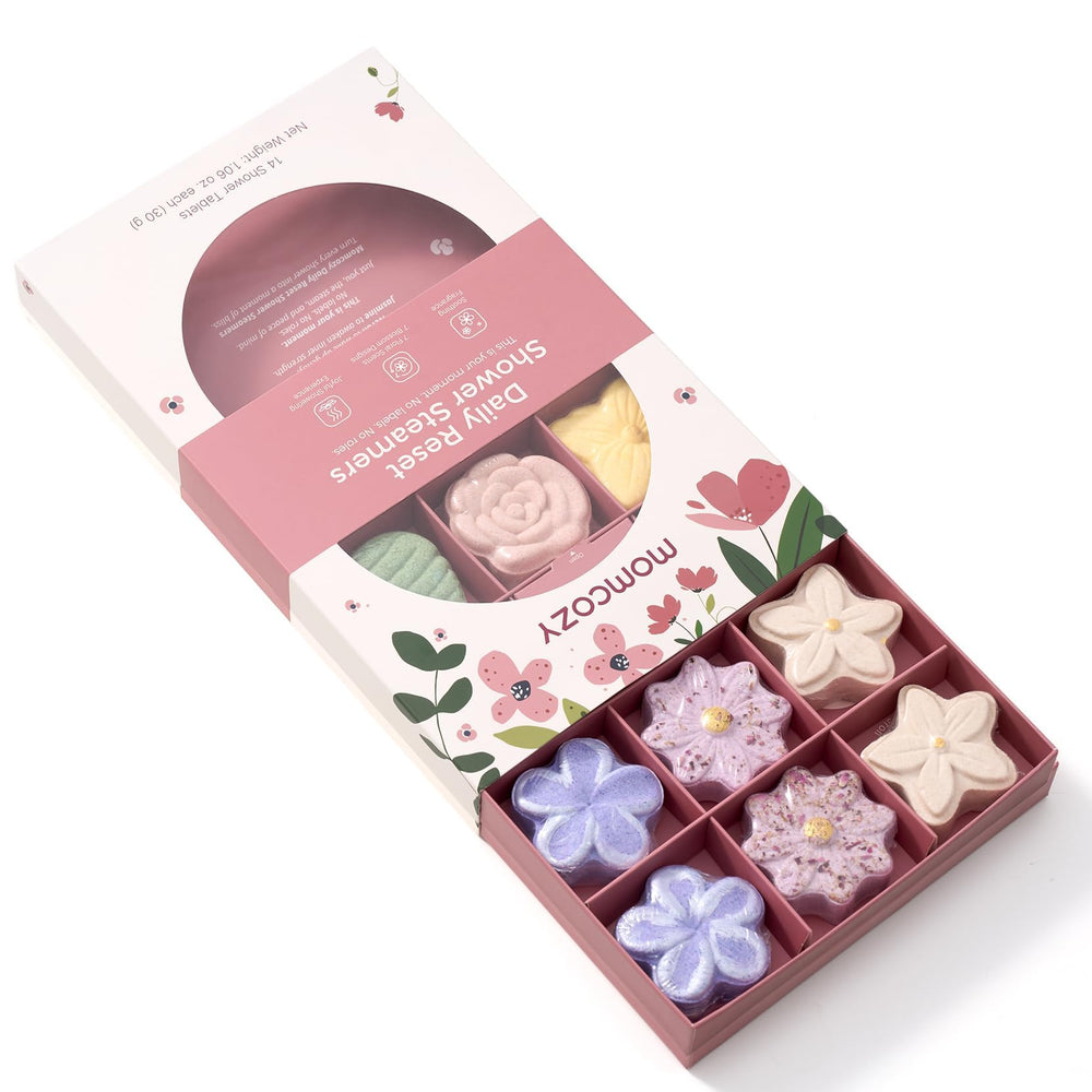 Momcozy steamers placed on a shower floor create a gentle scent during use.