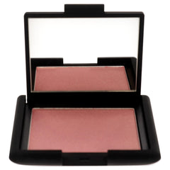 NARS Orgasm blush swatch on cheek showing natural radiance.