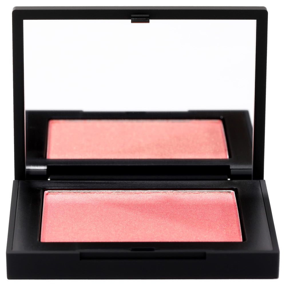 NARS Orgasm peachy-pink shimmer swatch on skin for radiant cheeks.
