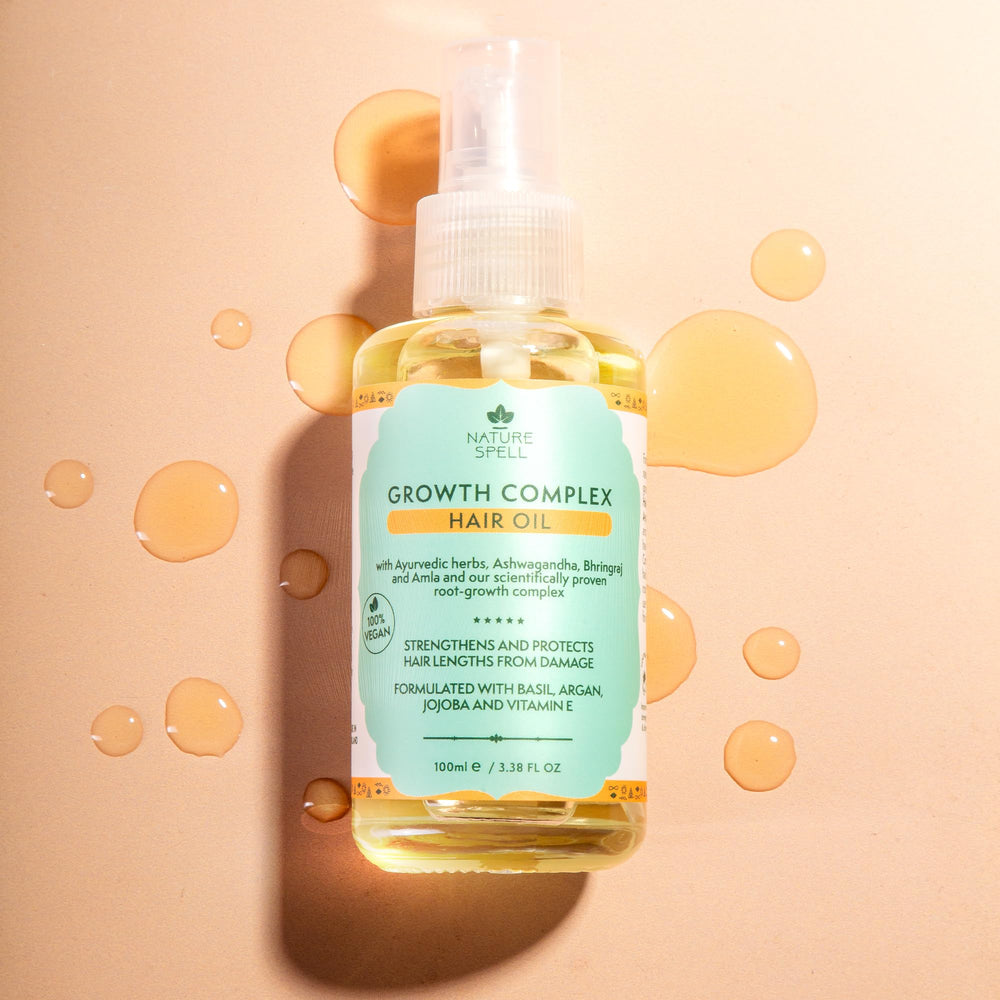 Nature Spell apply drops damp hair demonstrates easy, targeted use for mid-lengths and ends.