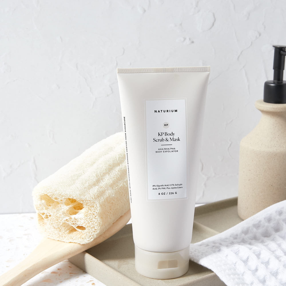 Naturium KP body scrub in-shower scene illustrating routine exfoliation