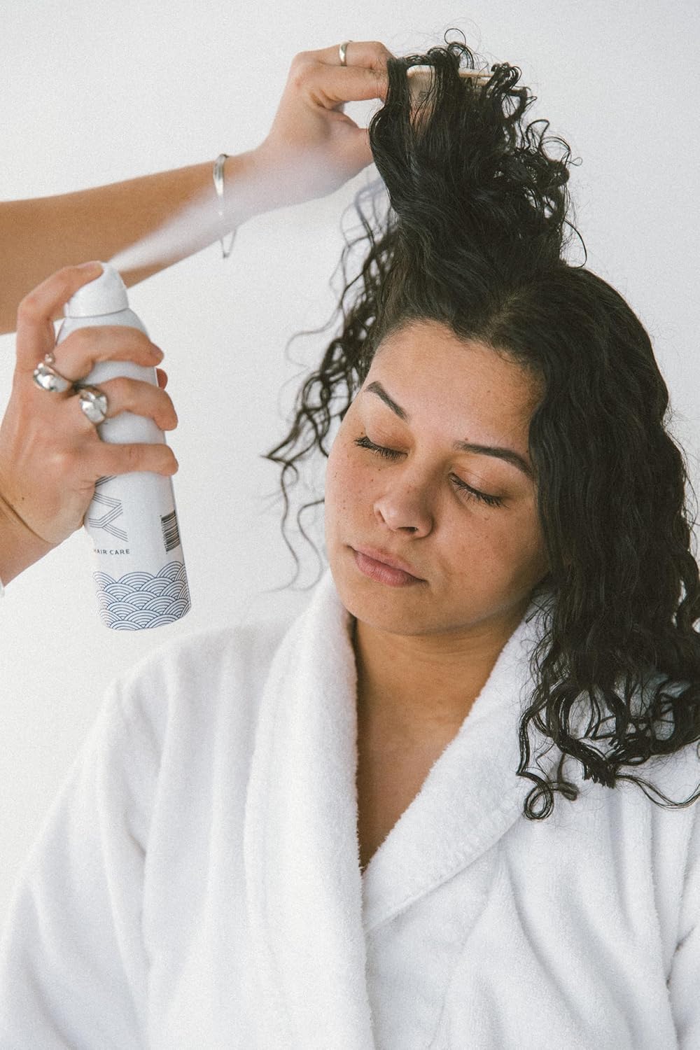 NAVY HAIR CARE Dry Texture Spray misting on dry hair for lift