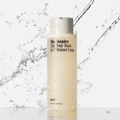 Nécessaire Hinoki bottle label close-up emphasizes clean additives and vegan formula.