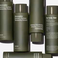 Nécessaire Rosemary Shampoo rosemary oil visual, evoking scalp-refreshing, aromatic ritual.