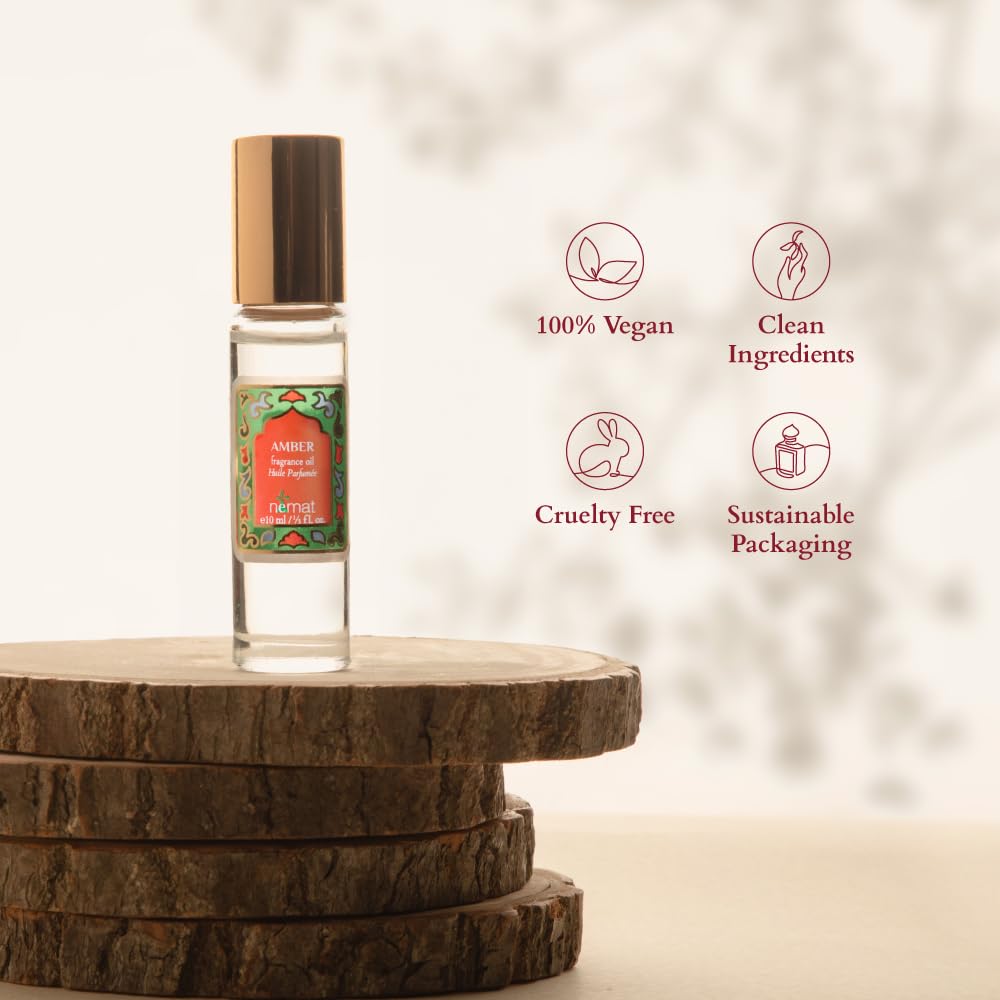 Nemat Amber Perfume Oil glass bottle on mirror reveals rich amber notes